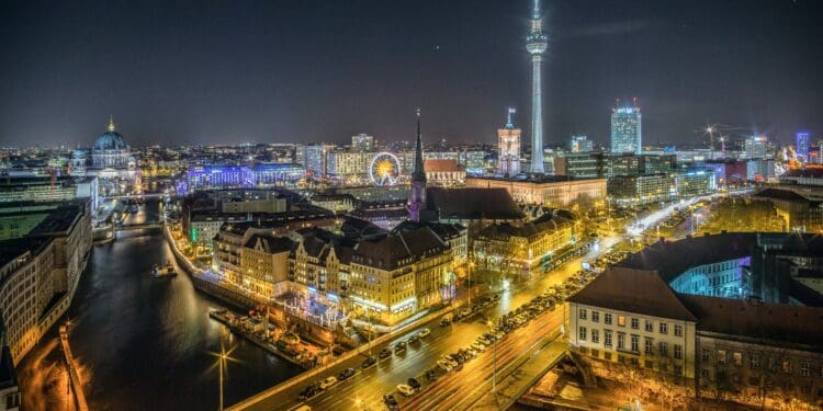 View over the River Spree to Nikolaiviertel and Alexanderplatz. The Nikolaiviertel is the reconstructed historical heart of the German capital Berlin. The Nikolaikirche (Saint Nicholas Church) gives its name to the neighbourhood five minutes away from Alexanderplatz. The Alexanderplatz is a large public square and transport hub in the central Mitte district of Berlin, near the Fernsehturm the Rotes Rathaus, the town hall of Berlin.