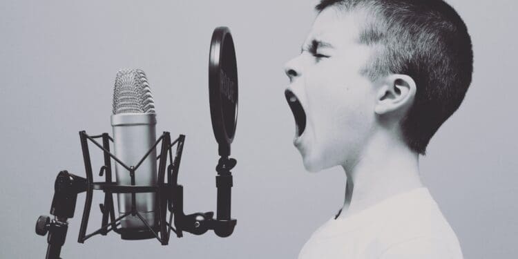 boy singing on microphone with pop filter