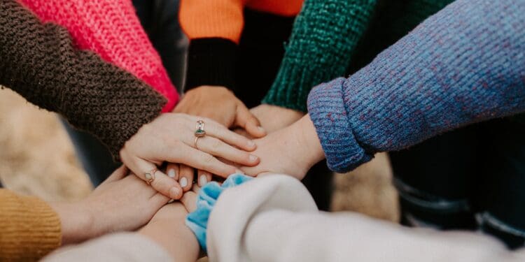 girl friends hands piled togethger