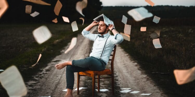 man sitting on chair with book
