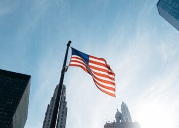 USA flag on pole at the city during day