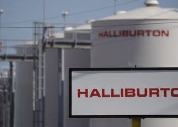 Halliburton Co. signage is displayed alongside storage tanks in Port Fourchon, Louisiana, U.S., on Thursday, June 11, 2020. Oil eclipsed $40 a barrel in New York on Friday, extending a slow but relentless rise thats been fueled by a pick-up in demand and could signal a reawakening for U.S. shale production. Photographer: Luke Sharrett/Bloomberg
