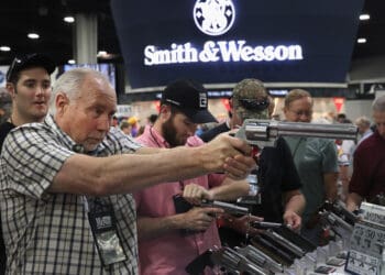 ATLANTA, GA - APRIL 29:  National Rifle Association members look over pistols in the Smith & Wesson display at the 146th NRA Annual Meetings & Exhibits on April 29, 2017 in Atlanta, Georgia. With more than 800 exhibitors, the convention is the largest annual gathering for the NRA's more than 5 million members.  (Photo by Scott Olson/Getty Images)