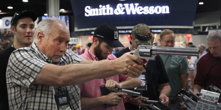 ATLANTA, GA - APRIL 29:  National Rifle Association members look over pistols in the Smith & Wesson display at the 146th NRA Annual Meetings & Exhibits on April 29, 2017 in Atlanta, Georgia. With more than 800 exhibitors, the convention is the largest annual gathering for the NRA's more than 5 million members.  (Photo by Scott Olson/Getty Images)