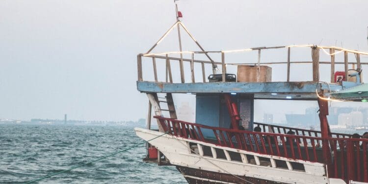 white and brown powerboat surrounded by body of water