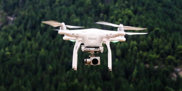 White drone mid-flight