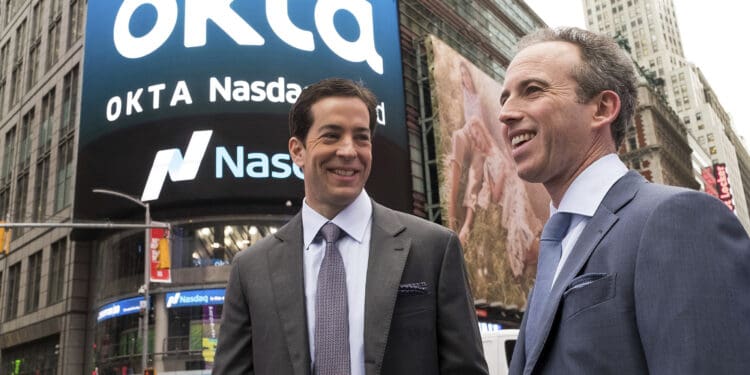 IMAGE DISTRIBUTED FOR OKTA - Okta co-founders Todd McKinnon, left, and Frederic Kerrest stand in Times Square after the company's initial public offering (IPO) at the NASDAQ stock exchange on Friday, April 7, 2017 in New York. Okta is the leading independent provider of identity for the enterprise. The Okta Identity Cloud connects and protects employees of many of the world's largest enterprises. It also securely connects enterprises to their partners, suppliers and customers. (Charles Sykes/AP Images for OKTA)