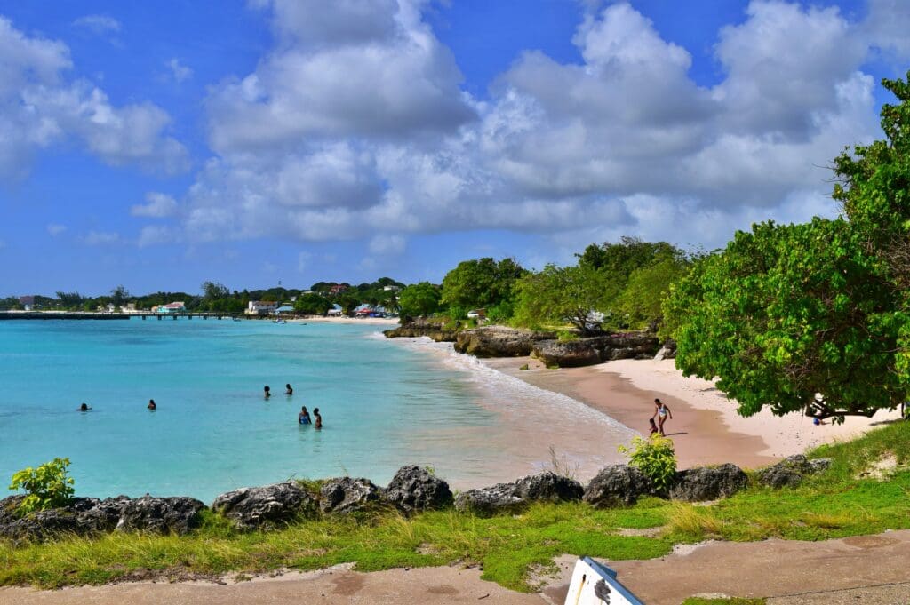 A typically sunny day in paradise, a beach Barbados with white sand and crystal clear water. Caribbean sea lapping the shore.