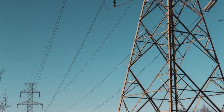 brown electric post under blue sky during daytime