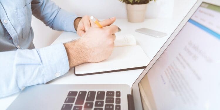 Businessman working and writing notes in office