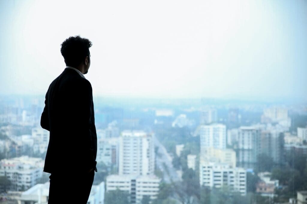 High Ambition
Man in Black Suit Standing on Top of Building Looking At City Buildings