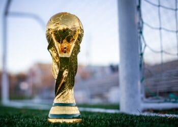 international football trophy sitting on soccer field near the goals