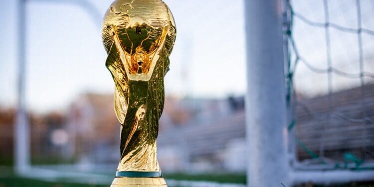 international football trophy sitting on soccer field near the goals
