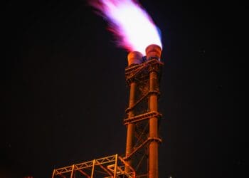 Low angle view of illuminated tower against sky at night