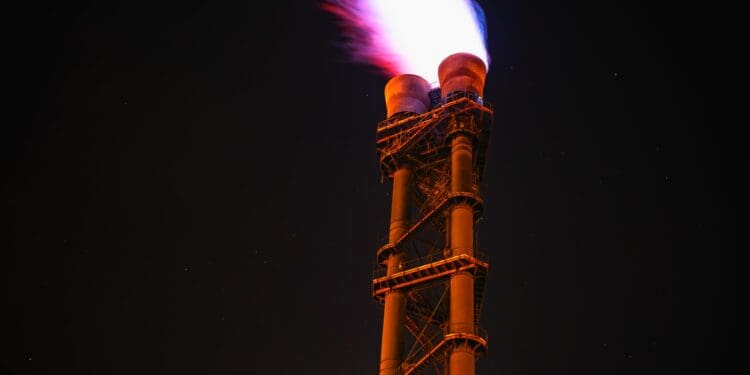 Low angle view of illuminated tower against sky at night