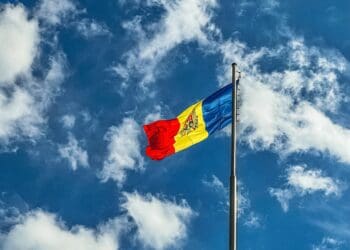 red blue and yellow flag under blue sky during daytime