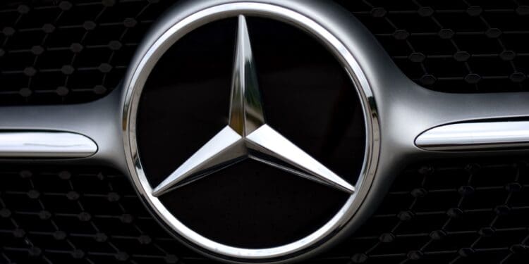 silver mercedes benz emblem on black car