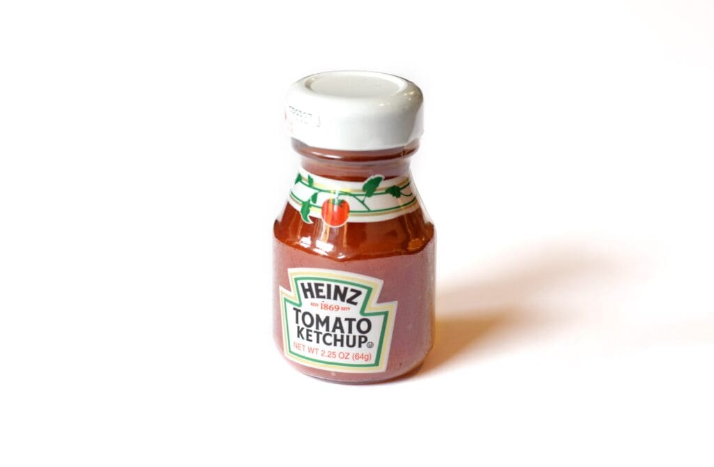 A small bottle of Heinz Tomato Ketchup.