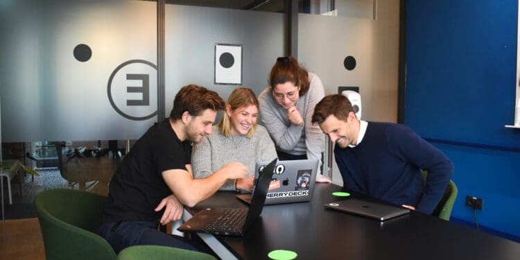 people sitting on chair in front of laptop computers
