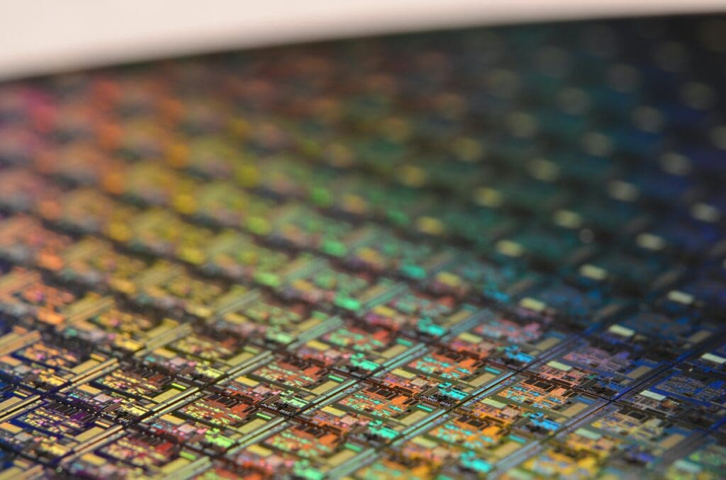 This is a macro of a silicon wafer. Each square is a chip with microscopic transistors and circuits. Ordinarily, wafers like these are diced into their individual chips and the chips go into the processors that power our computers.
Sometimes, wafers have flaws and the manufacturers dispose of them instead. That’s how I got mine. After visiting the tech museums in Silicon Valley, I was amazed at the beauty of silicon wafers, so I started collecting and photographing them.
Like fractals and flowers, the closer you get to them, the more amazing details there are to see.