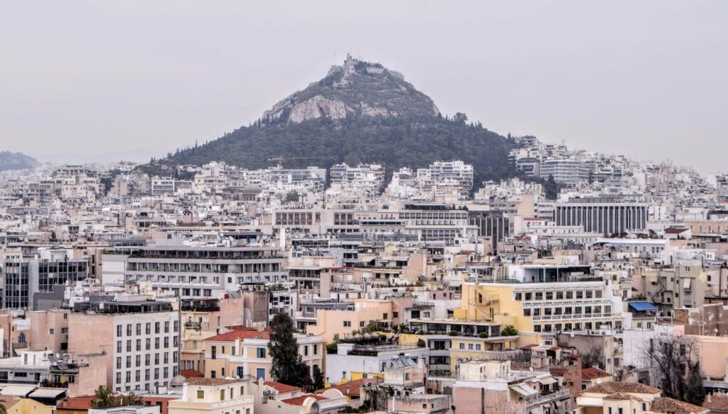 white and brown concrete buildings near mountain during daytime