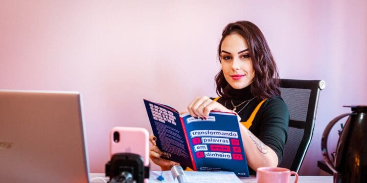 woman in black and yellow crew neck t-shirt holding blue and white box