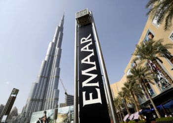 An Emaar Properties PJSC sign stands beside billboards promoting the Opera district developments near the Burj Khalifa tower in Dubai, United Arab Emirates, on Friday, Nov. 7, 2014. Dubai invested billions of dollars to become a regional trade, tourism and financial hub although it doesn't have a substantial oil revenue like fellow Gulf Arab sheikhdoms. Photographer: Chris Ratcliffe/Bloomberg