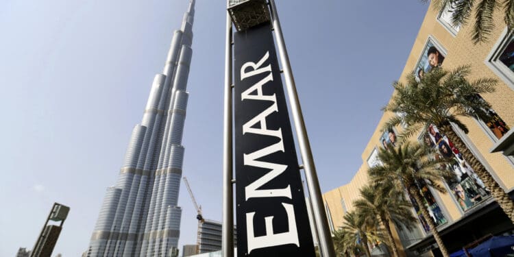 An Emaar Properties PJSC sign stands beside billboards promoting the Opera district developments near the Burj Khalifa tower in Dubai, United Arab Emirates, on Friday, Nov. 7, 2014. Dubai invested billions of dollars to become a regional trade, tourism and financial hub although it doesn't have a substantial oil revenue like fellow Gulf Arab sheikhdoms. Photographer: Chris Ratcliffe/Bloomberg