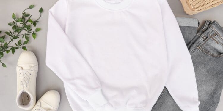 Blank and plain white sweater mockup photo with jeans and sneakers on the background. Use it to display your apparel design.