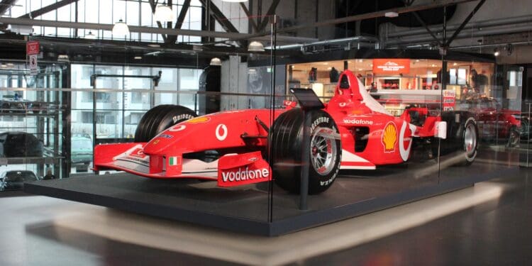red ferrari f 1 on gray pavement