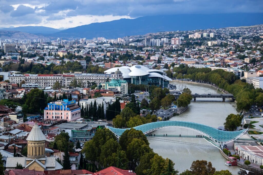 Tbilisi is a city of contrasts: a meeting point between eastern and western civilisations for centuries, it remains one today. Built along the riverbank of the Kura <noread>(Mtkvari, in Georgian)</noread> and surrounded by hills, Tbilisi has been settled since before the 4th century, but boasts a skyscape that includes twenty - first century architecture. Tbilisi can be international, cosmopolitan and sophisticated, yet it is essentially and distinctly Georgian and retains a close focus on local tradition and culture.