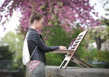 woman working outdoors on a standing desk