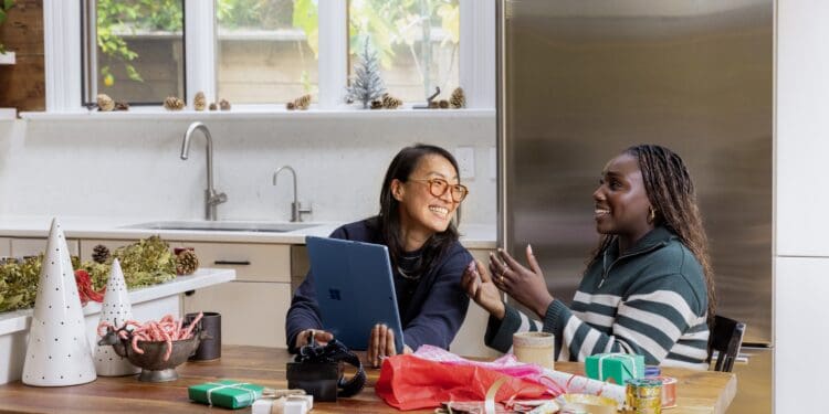 a woman sitting at a table in front of a window