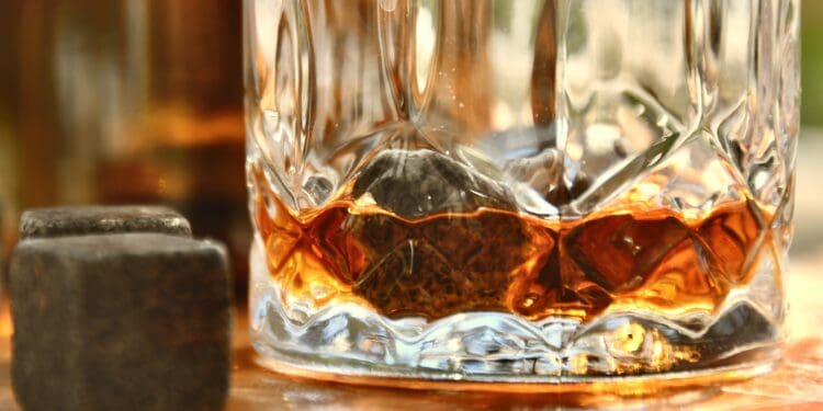 clear drinking glass with brown liquid