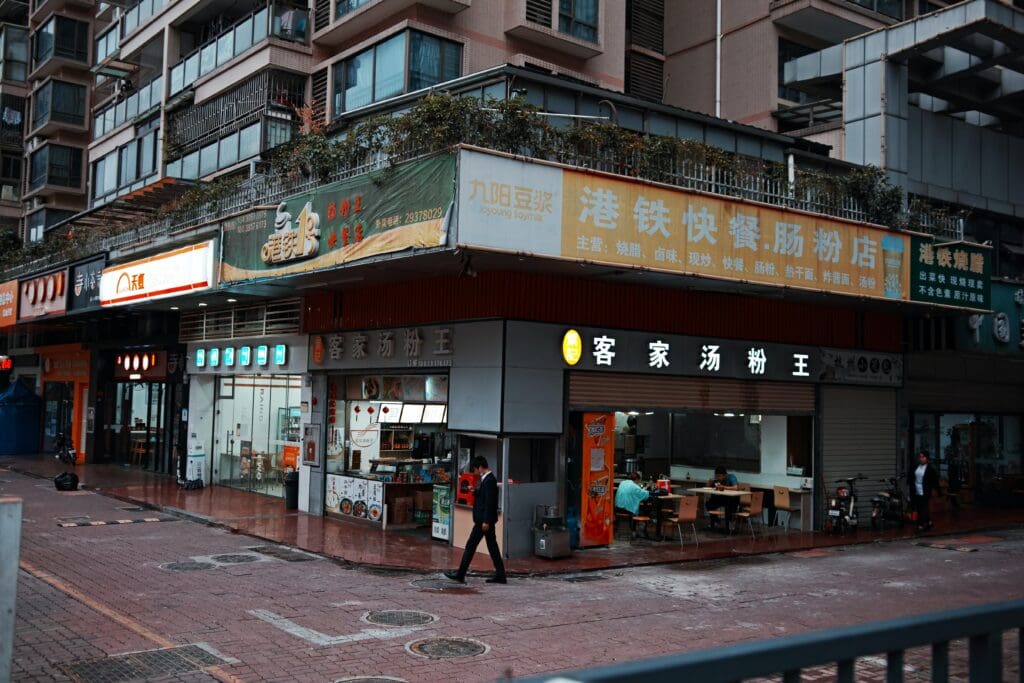 people walking on sidewalk near store during daytime