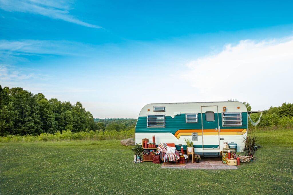 Retro vintage camper in a field.Follow this camper on Instagram: @FawkesThePhoenixCamper