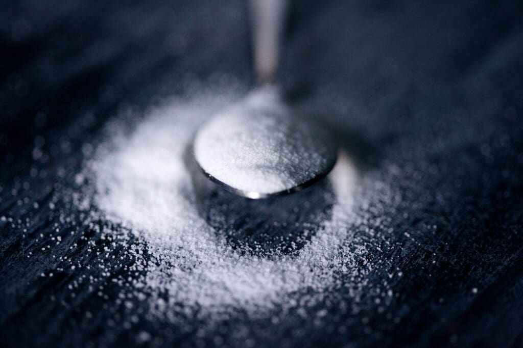 White sugar on a spoon.