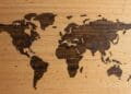 Wooden map of the world with pins