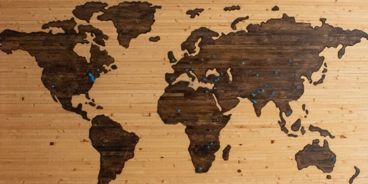 Wooden map of the world with pins