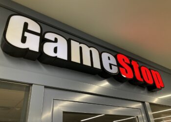Zug, Switzerland - 6th February 2021 : GameStop logo hanging over a store entrance in Zug, Switzerland. GameStop is an American company that sells video game