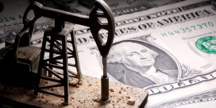 FILE PHOTO: A 3D-printed oil pump jack is placed on dollar banknotes in this illustration picture, April 14, 2020. REUTERS/Dado Ruvic/Illustration