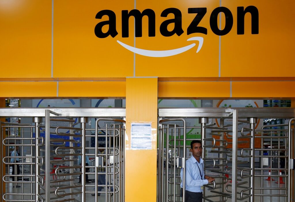 FILE PHOTO: An employee of Amazon walks through a turnstile gate inside an Amazon Fulfillment Centre <noread>(BLR7)</noread> on the outskirts of Bengaluru, India, September 18, 2018. REUTERS/ Abhishek N. Chinnappa/File Photo