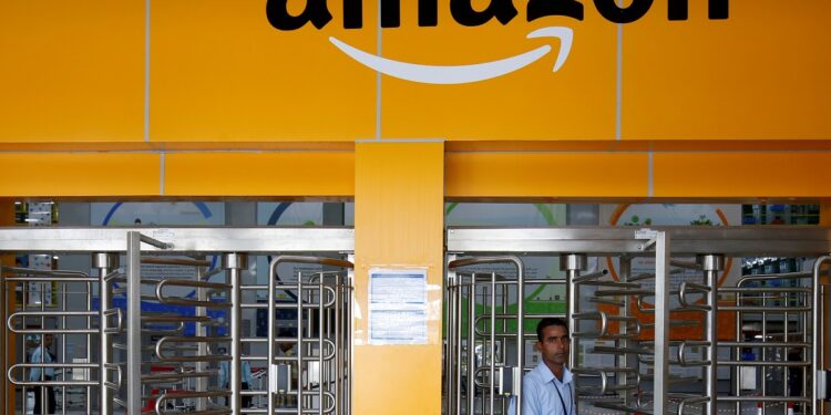 FILE PHOTO: An employee of Amazon walks through a turnstile gate inside an Amazon Fulfillment Centre (BLR7) on the outskirts of Bengaluru, India, September 18, 2018. REUTERS/ Abhishek N. Chinnappa/File Photo