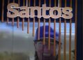 FILE PHOTO: The logo of Australian oil and gas exploration and production company Santos is displayed during the LNG 2023 energy trade show in Vancouver, British Columbia, Canada, July 12, 2023. REUTERS/Chris Helgren/ File Photo