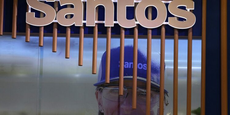 FILE PHOTO: The logo of Australian oil and gas exploration and production company Santos is displayed during the LNG 2023 energy trade show in Vancouver, British Columbia, Canada, July 12, 2023. REUTERS/Chris Helgren/ File Photo