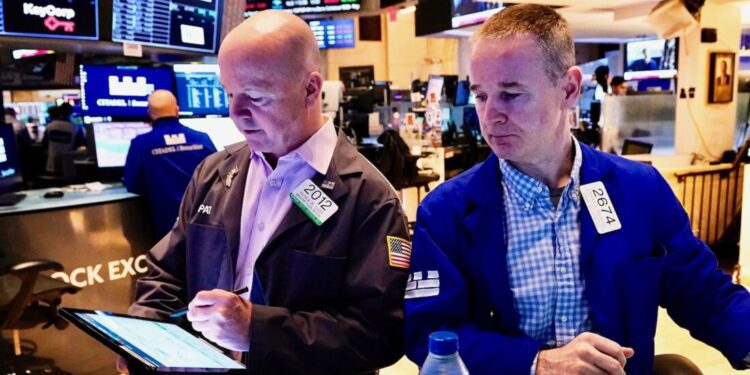 Trader Patrick Casey, left, and specialist Stephen Naughton work on the floor of the New York Stock Exchange, Friday, April 25, 2025. (AP Photo/Richard Drew)