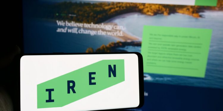 Stuttgart, Germany - 05-02-2024: Person holding mobile phone with logo of Australian Bitcoin mining company Iris Energy Ltd. (IREN) in front of web page. Focus on phone display.