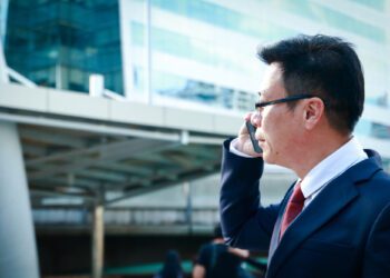 Asian businessmen wearing glasses, calling, talking to customers