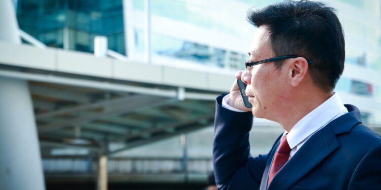 Asian businessmen wearing glasses, calling, talking to customers